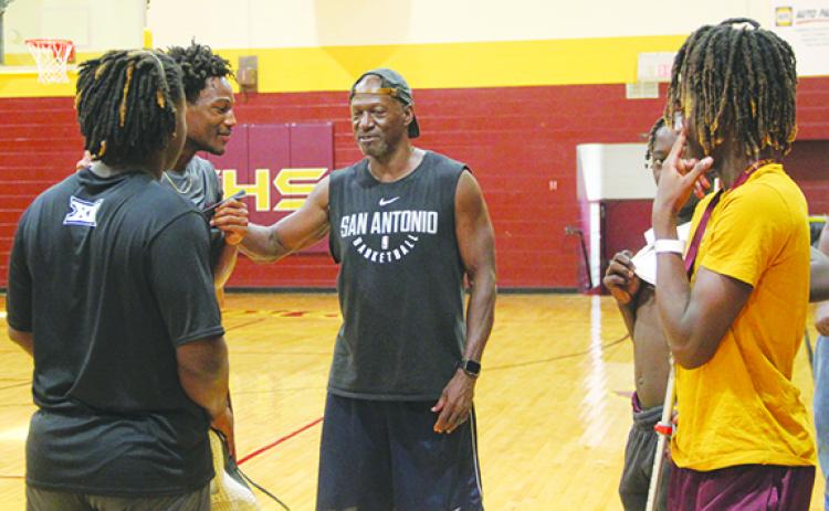 Crescent City Junior-Senior High School boys basketball coach Al Carter (center) talks with his players during a recent practice. (COREY DAVIS / Palatka Daily News)