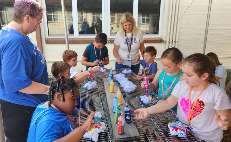 Submitted by Kirk Collier. Second graders learn the science behind using ice to make tie-dyed T-shirts during the Putnam County School District’s 2023 STEM Summer Camp.