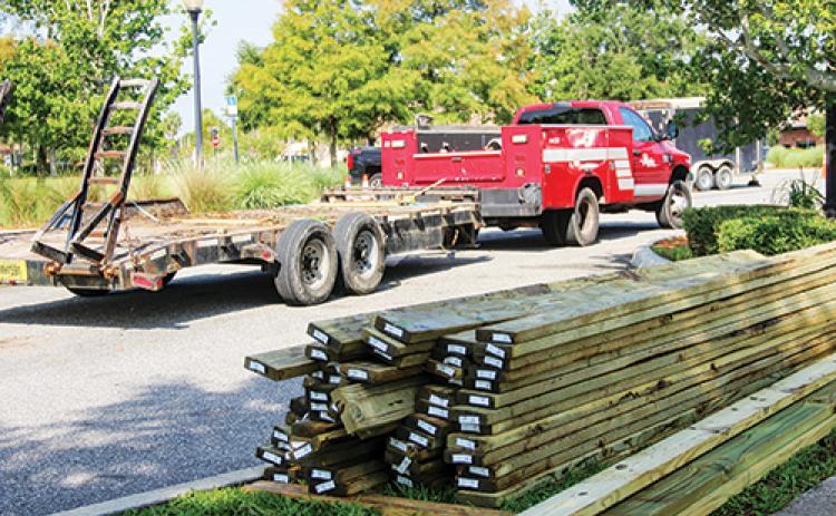 SARAH CAVACINI/Palatka Daily News -- Wooden planks at stacked at the Palatka riverfront Tuesday as workers carry out repairs on the boardwalk under Memorial Bridge.