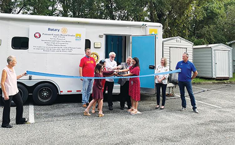 File photo -- Rotary Club of Palatka Sunrise members cut the ribbon to launch the Health Department dental trailer in August 2022.