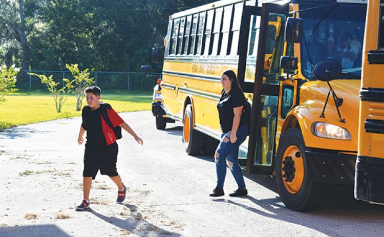 BRANDON D. OLIVER/Palatka Daily News -- Interlachen Junior-Senior High School students disembark from a school bus on the first day of the 2023-2024 academic year.