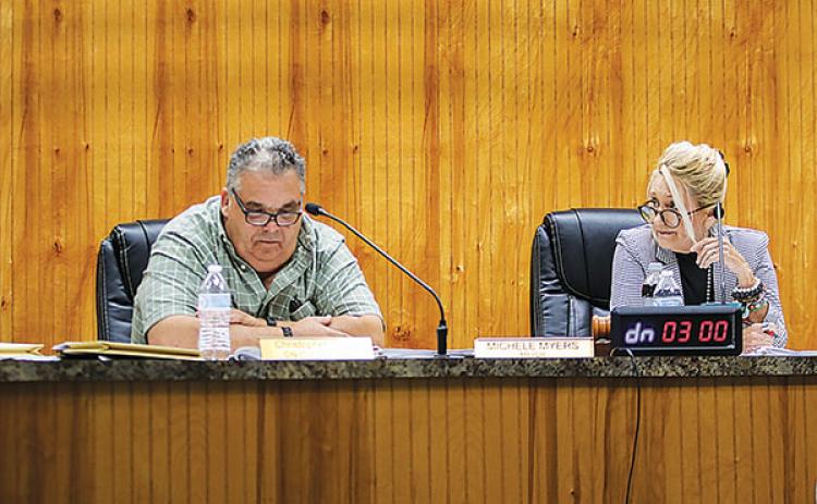 Crescent City Mayor Michele Myers, right, glances at then-Commissioner C.J. Bailey during a hot-topic conversation at a commission meeting in June.