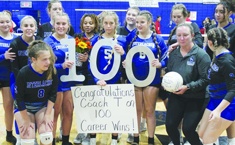 Interlachen Junior-Senior High School volleyball coach Tonya Troiano (with ball) celebrates her 100th career victory with her team after sweeping St. Augustine Florida D&B on Thursday. (MARK BLUMENTHAL / Palatka Daily News)