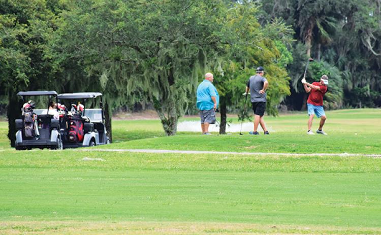 BRANDON D. OLIVER/Palatka Daily News – A group of men plays golf Wednesday afternoon at the Palatka Golf Club after it was clear the city had not sustained major damage from Hurricane Idalia.