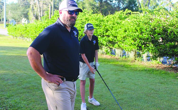 Palatka boys golf coach Jeff Malandrucco waits for the signal for Luke Meredith (right) to tee off during last year’s district tournament at the Palatka Municipal Golf Club. (MARK BLUMENTHAL / Palatka Daily News)