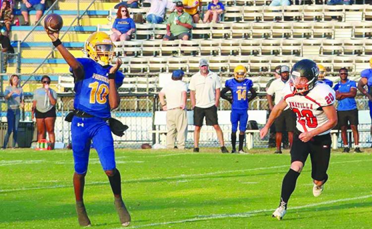 Palatka quarterback Tommy Offord (10) gets a pass off in front of Umatilla’s Nathaniel Frazier last Friday. (RITA FULLERTON / Special to the Daily News)