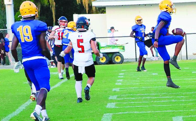 Palatka quarterback Tommy Offord (right) celebrates the first of his four touchdown runs en route to a 45-6 Panthers win over Umatilla Friday. (RITA FULLERTON / Special to the Daily News)