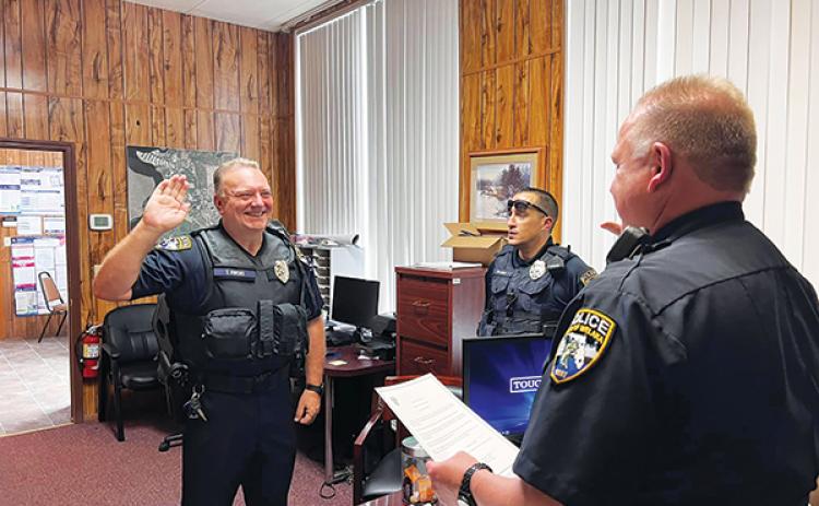 Photo courtesy of the town of Welaka – Welaka Police Chief Michael Porath, right, swears in Officer Tommy Owens last week.