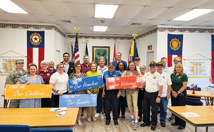 SARAH CAVACINI/Palatka Daily News – Local and regional officials stand together Tuesday inside America Legion Bert Hodge Post 45 in Palatka after discussing ways to help local veterans gain access to resources they need.