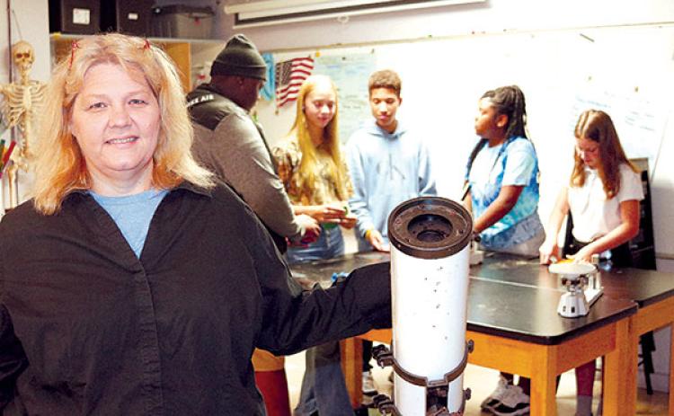 TRISHA MURPHY/Palatka Daily News Former Putnam Academy of Arts and Sciences teacher Christina Griffis stands next to a telescope while some of her students work on a project.