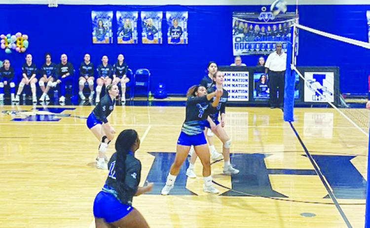 Ja'Taysia Sheppard (7) sends the ball over the net while her Interlachen teammates look on during their match with Pierson Taylor Monday night. (COREY DAVIS / Palatka Daily News)
