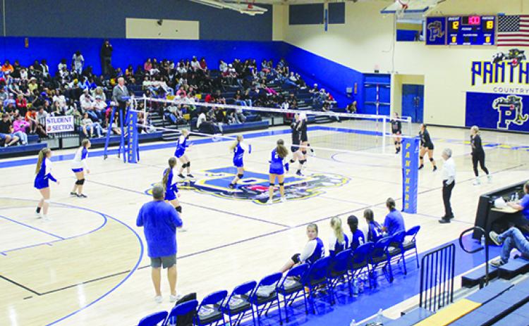 The new court at Palatka Junior-Senior High School is broken in on Sept. 1 as action takes place between Peniel Baptist Academy (foreground) and Palatka. Palatka won the match in front of its student body in four sets. (MARK BLUMENTHAL / Palatka Daily News)