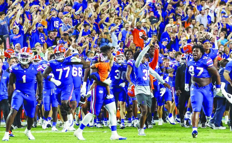 University of Florida fans and players celebrate the end of the Gators’ 29-16 victory over Tennessee in Gainesville Saturday night. (JOHN STUDWELL / Palatka Daily News)