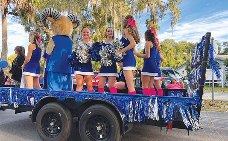 Submitted photo – Interlachen Junior-Senior High School varsity cheerleaders ride on a float during the school’s Homecoming Parade on Thursday.