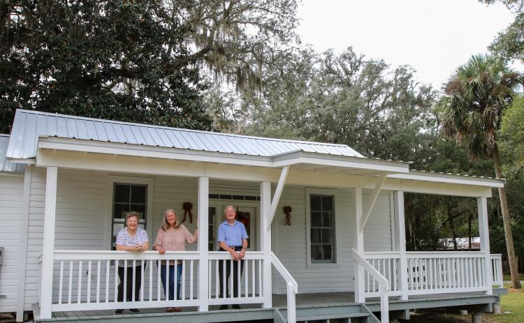 SARAH CAVACINI/Palatka Daily News. Meri-lin Piantanida (center) stands in 2022 on the porch of Florahome's Palmetto Hall with husband and wife Betty (left) and Ronnie Carnes (right). The historic clubhouse turned 100 years old this year. 