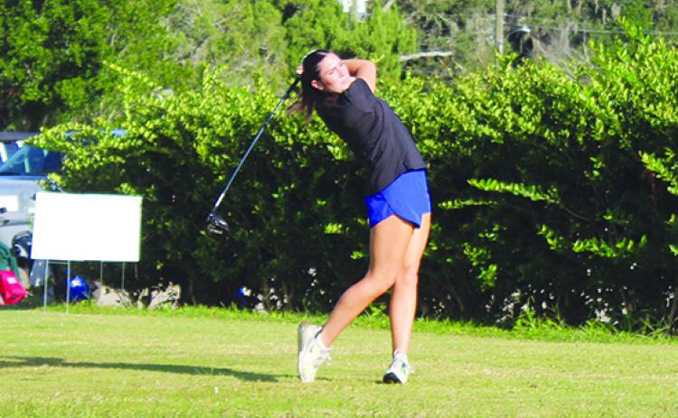 Palatka's Kaley Giddens watches her tee shot on the first hole during Monday's District 4-2A championship at the Palatka Municipal Golf Club. (MARK BLUMENTHAL / Palatka Daily News)