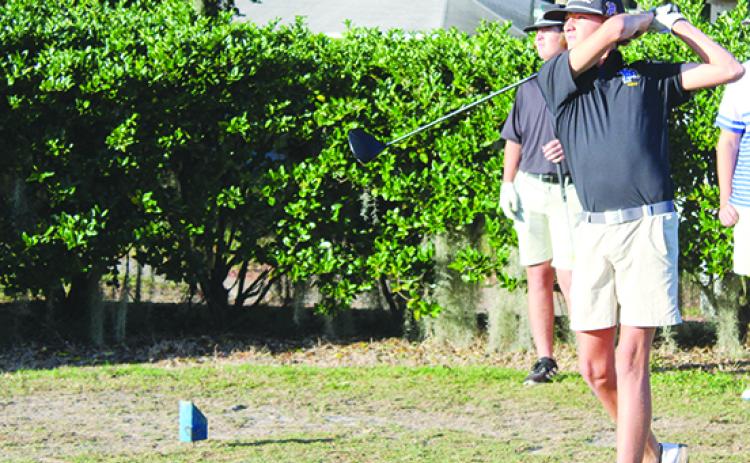Palatka’s Luke Meredith watches his drive on the first tee during Tuesday’s District 4-2A tournament. (MARK BLUMENTHAL / Palatka Daily News)