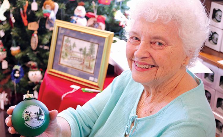 TRISHA MURPHY/Palatka Daily News – Carolyn Stevens holds this year’s Christmas in Putnam County keepsake ornament that will be on sale at Holiday House, which opens this weekend. 