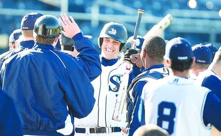 Nathaniel Lowe is all smiles greeting St. Johns River State College teammates after belting a two-run home run at home against Broward on Feb. 13, 2015. (Daily News file photo)
