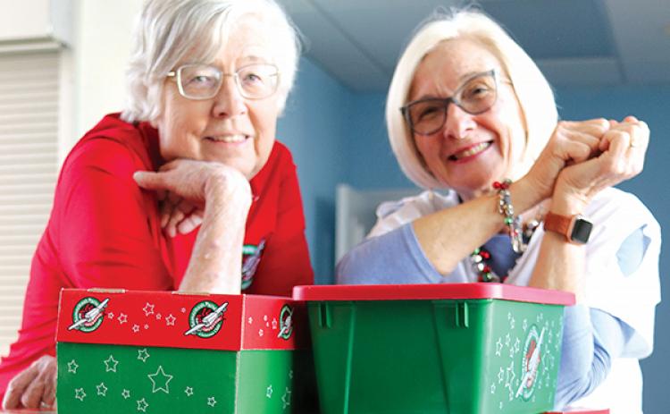 TRISHA MURPHY/Palatka Daily News – Elaine Clark, left, and Cynthia Adams are pictured with shoeboxes filled with toys and other items First Baptist Church of Palatka members have donated for Samaritan’s Purse Operation Christmas Child.