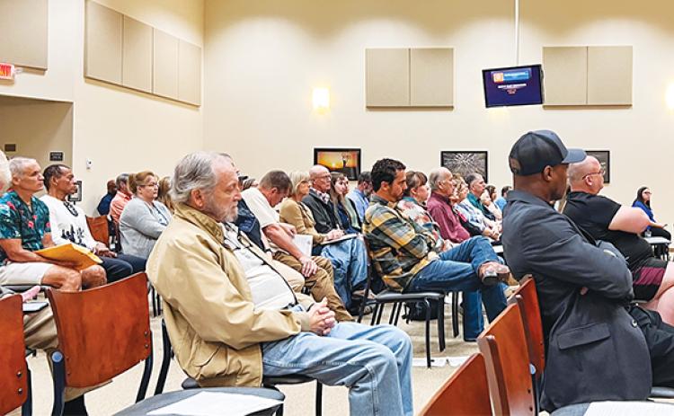 SARAH CAVACINI/Palatka Daily News – Putnam and Clay County residents listen Tuesday morning as people speak about a proposed glamping and camping venue that was later struck down.