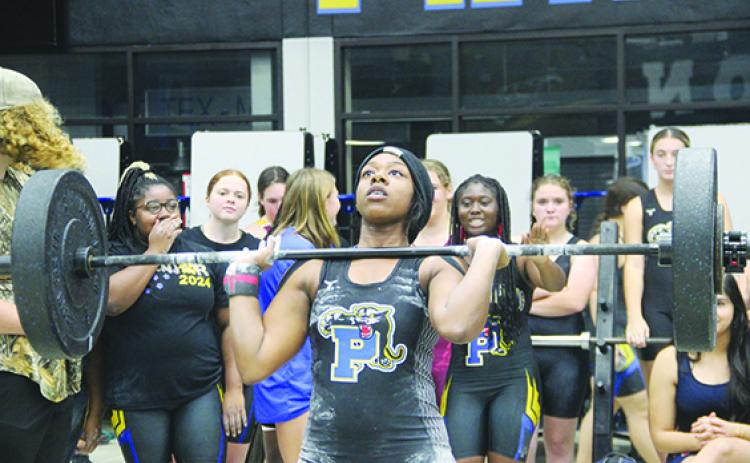 Palatka weightlifter Al’Lyssa Ford, seen here during the clean and jerk, won titles in her 169-pound class in Olympic and traditional competitions at Friday’s Feast Mode event at Palatka Junior-Senior High School. (COREY DAVIS / Palatka Daily News)