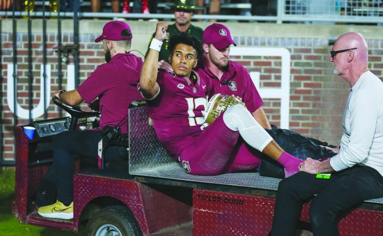 Florida State quarterback Jordan Travis acknowledges the crowd at Doak Campbell Stadium after getting seriously hurt last Saturday against North Alabama. (GREG OYSTER / Special to the Daily News)