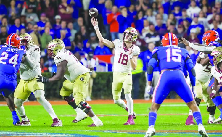 Florida State quarterback Tate Rodemaker is protected in the pocket as he launches a pass during the Seminoles’ 24-15 victory over Florida Saturday night at Ben Hill Griffin Stadium. (GREG OYSTER / Special to the Daily News)