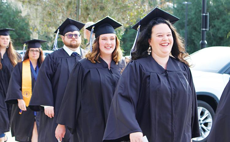 Photos submitted by Susan Kessler – Sylvie Moody, far right, leads a group of St. Johns River State College graduates as they prepare for their commencement ceremony Thursday in Orange Park.