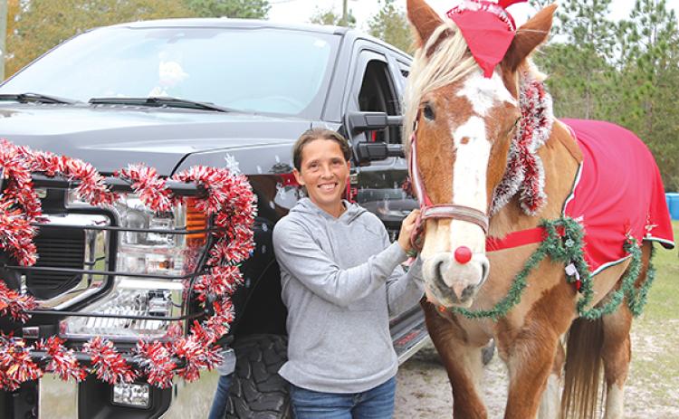 TRISHA MURPHY/Palatka Daily News – Daniela Cantana stands with Meeko, a Belgian rescue horse at Hope’s Dream Rescue and Sanctuary in Bardin. The two will participate in the community’s Christmas parade Sunday.