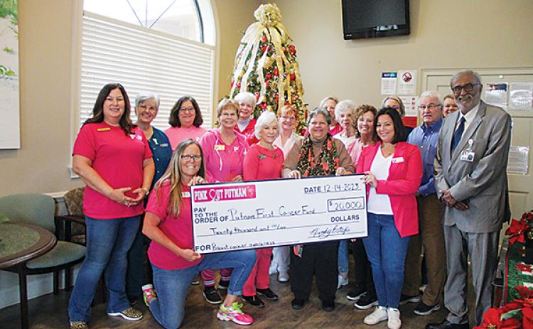 SARAH CAVACINI/Palatka Daily News – Pink Out Putnam members hand over a $20,000 check to the Putnam First Cancer Fund last week.