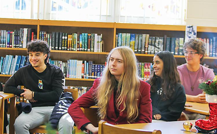 SARAH CAVACINI/Palatka Daily News - Q.I. Roberts Junior-Senior High School students Noah Lotow, Gavin Miles, Leah Zabad and Matthew Snider talk about the Cambridge program with school district and state officials.