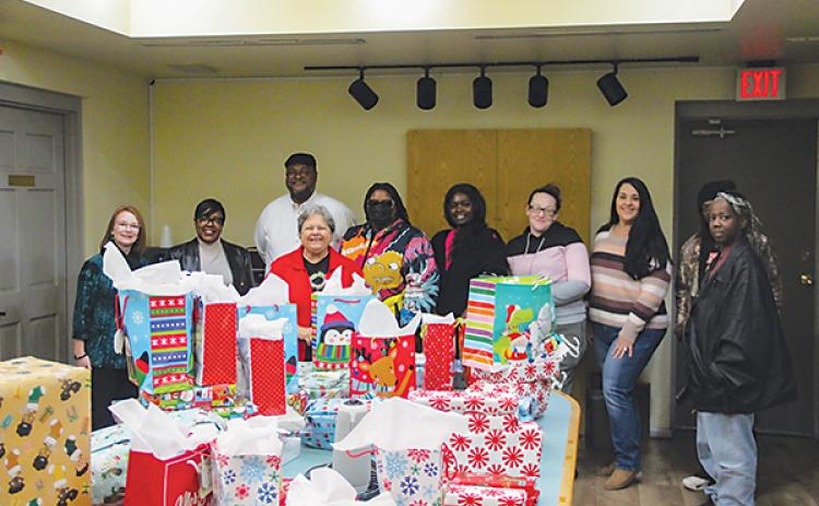 SARAH CAVACINI/Palatka Daily News – Palatka Housing Authority employees and residents as well as Rotary Club of Palatka volunteers gather Wednesday for a Christmas gift giveaway.