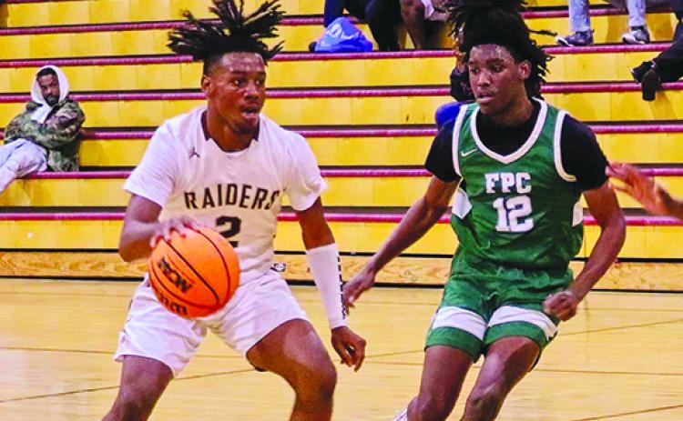 Crescent City’s Eric Jenkins Jr. dribbles the ball while Flagler Palm Coast’s Nateshawn Royal comes over to help out on defense Thursday night. (RITA FULLERTON / Special to the Daily News)