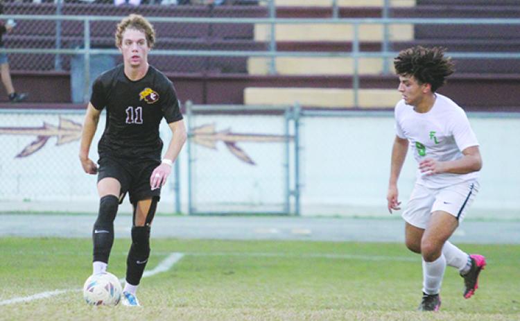 Seen here in the first-round matchup last Thursday against Daytona Beach Father Lopez, Crescent City’s Levi Keefauver (left) scored the tying goal in the second half as the fourth-seeded Raiders upset the top-seeded and defending 3A state champion Saints of Winter Park Trinity Prep in penalty kicks Saturday night in the District 9-3A tournament semifinal round at Wisnoski Field at Wiltcher Stadium. (MARK BLUMENTHAL / Palatka Daily News)