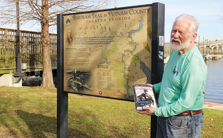 SARAH CAVACINI/Palatka Daily News - Bartram Trail Society of Florida President Sam Carr holds the January-February issue of Smithsonian Magazine while standing in front of a Bartram Trail marker in Palatka.