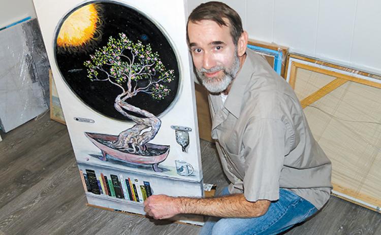 TRISHA MURPHY/Palatka Daily News – Toby Jones is pictured with his favorite art piece, “Azaleas in Orbit,” which will be showcased along with his other works Friday at the Larimer Arts Center.