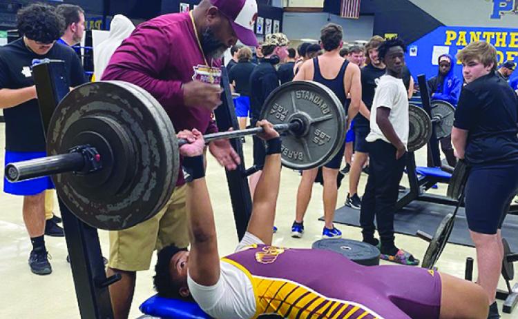 With head coach Troy Henry in position to spot him, Crescent City 238-pounder Zay Robinson prepares to compete in bench press on Wednesday. (COREY DAVIS / Palatka Daily News)