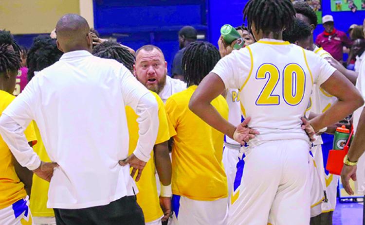 Palatka boys basketball coach Bryan Walter talks to his team during a timeout in Saturday’s District 5-4A championship victory. (RITA FULLERTON / Special to the Daily News)