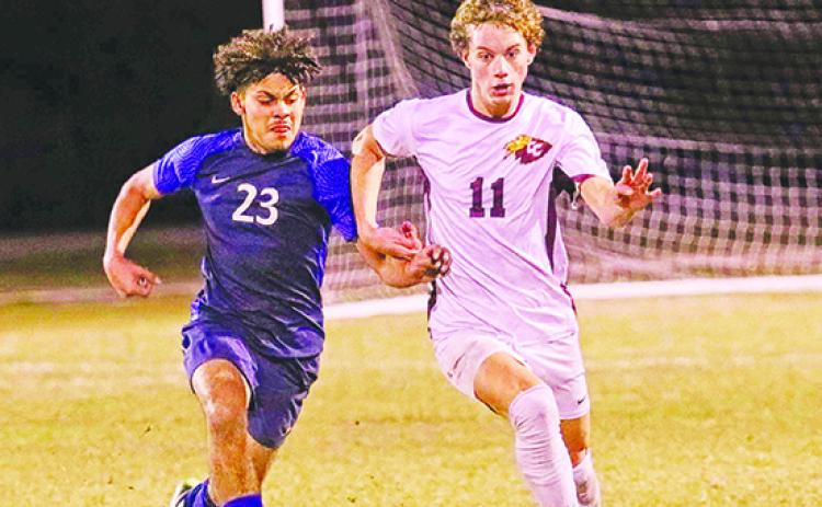 Crescent City’s Levi Keefauver (11) brings the ball up against Pierson Taylor’s Danny Carballo Wednesday night. (RITA FULLERTON / Special to the Daily News)
