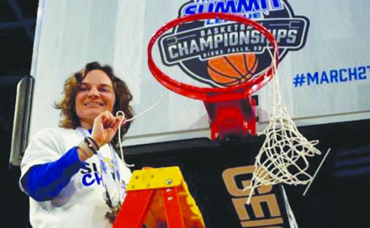 Loran Strunk takes a piece of the net last week after South Dakota State’s women’s basketball team won the Summit Tournament championship. (Submitted photo)