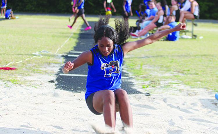 Palatka’s Destiny Williams lands in the sand after completing an attempt in the triple jump. The freshman won both the triple jump and high jump. (MARK BLUMENTHAL / Palatka Daily News)
