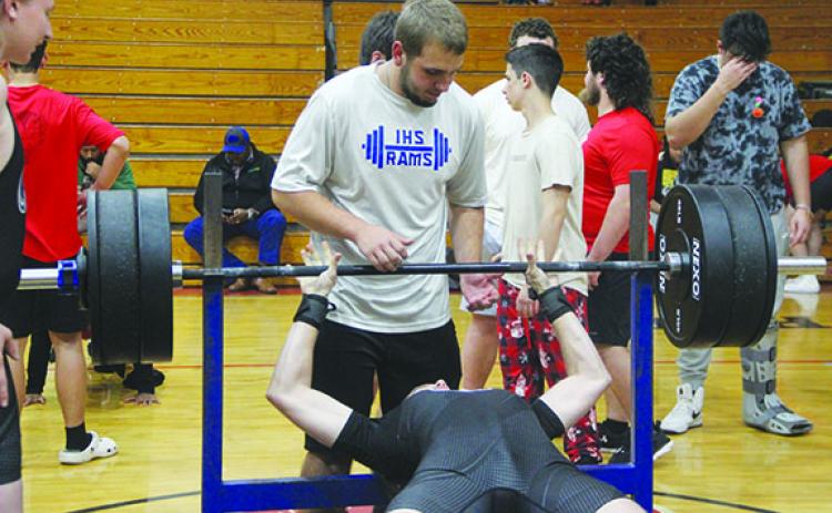 Interlachen’s Lial Landry attempts to bench press during his 169-pound weight class while teammate Zack Link spots him on Wednesday. (COREY DAVIS / Palatka Daily News)