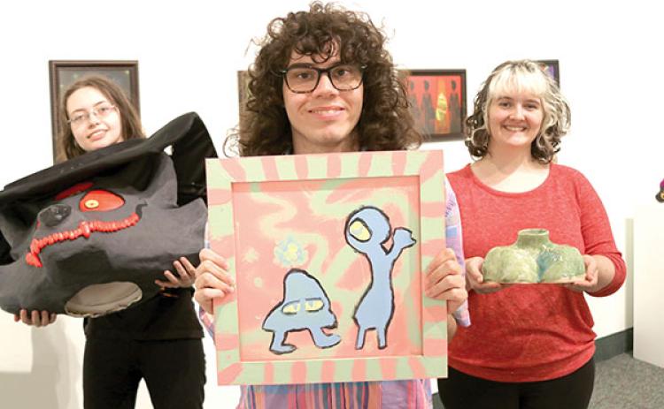 TRISHA MURPHY/Palatka Daily News – Florida School of the Arts students, from left, Vanessa Heymanowski, Trey Meyers and Brynn Lacouture hold some of their artworks that will be on display at the school’s Graduate Exhibition, which begins Thursday.