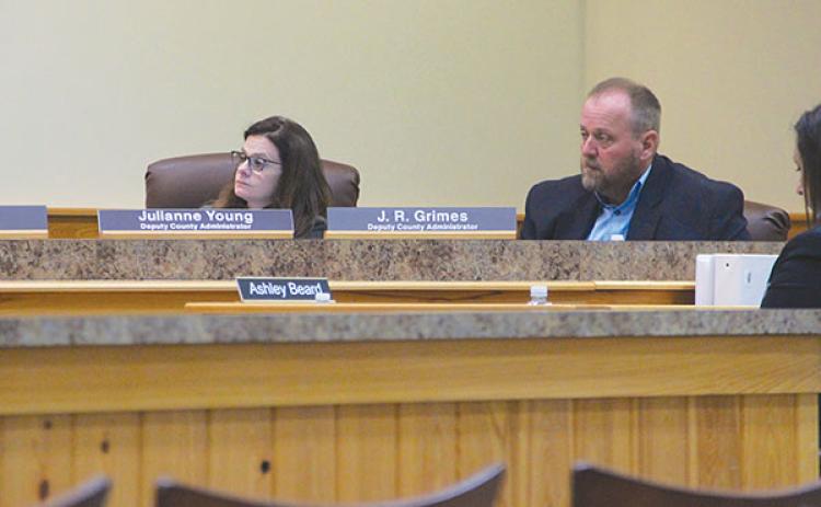 SARAH CAVACINI/Palatka Daily News – Deputy County Administrators Julianne Young, left, and J.R. Grimes listen to members of the Board of County Commissioners ask questions during Tuesday’s meeting.