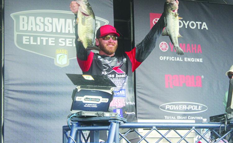 Caleb Sumrall of New Iberia, Louisiana, holds up some of his tournament-leading 28 pounds, 8 ounces of fish caught on Thursday along the Palatka City Docks. (MARK BLUMENTHAL / Palatka Daily News)