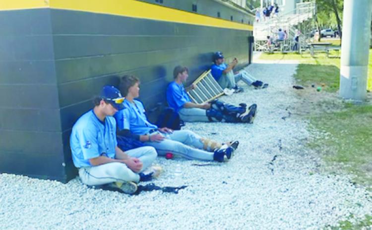 St. Johns River State College baseball players sit dejectedly behind their dugout after losing the opening game of a doubleheader Friday, giving Pasco-Hernando the Sun-Lakes Conference title. (COREY DAVIS / Palatka Daily News)