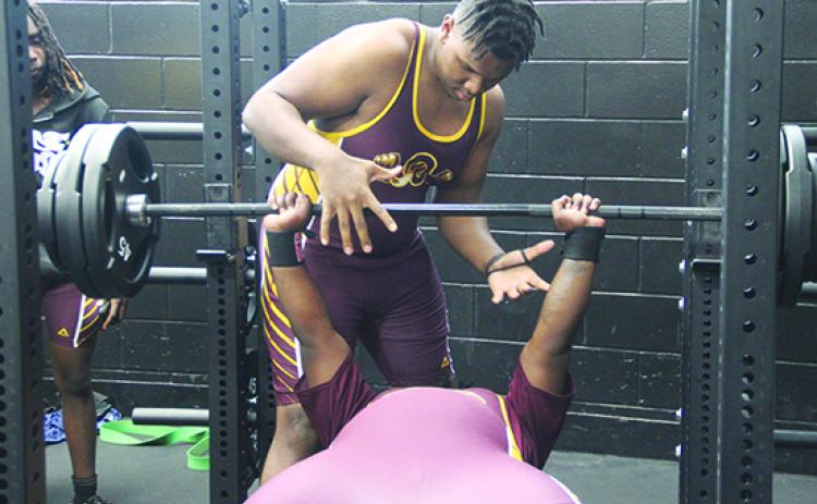 Here helping a teammate in the bench press during his team’s meet at Interlachen, Crescent City’s Jeremiah Odom will be competing in the Region 3-1A championship Friday in the unlimited division. (COREY DAVIS / Palatka Daily News)