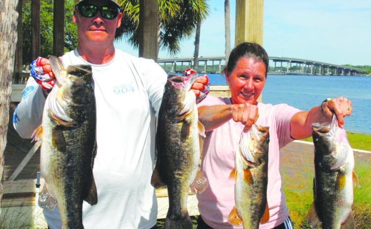 Brian and Michelle hold up their winning fish in the Andy Lawrence Open Bass Tournament. (GREG WALKER / Daily News correspondent)