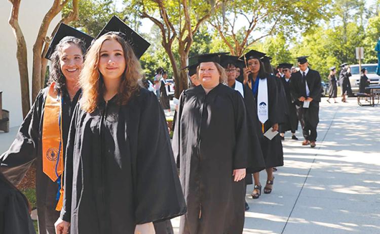 Photo submitted by Susan Kessler – Erin Jacobsen, foreground, and her mother, Shannon Jacobsen, left, prepare to participate in the St. Johns River State College spring commencement ceremony Friday.
